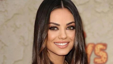 Mila Kunis souriante, symbolisant son retour réussi à Hollywood post-scandale