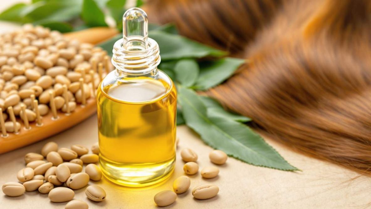 Flacon d’huile de ricin avec gouttes d’huile et cheveux brillants