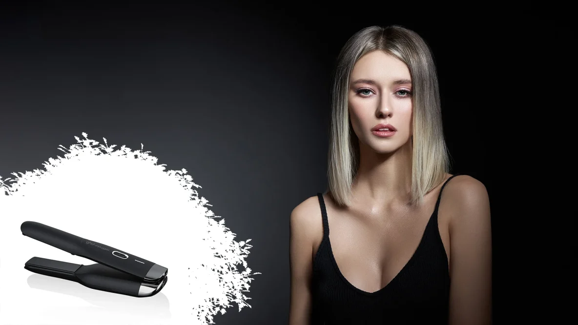 Fille blonde avec robe noire et aux cheveux lisses avec un lisseur sans fil GHD